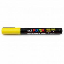 Yellow POSCA marker lying horizontally on a white background