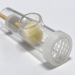 Close-up of clear tube with side opening, foam pads and mesh cap