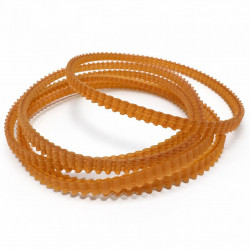 Several translucent orange toothed belts on a white studio background