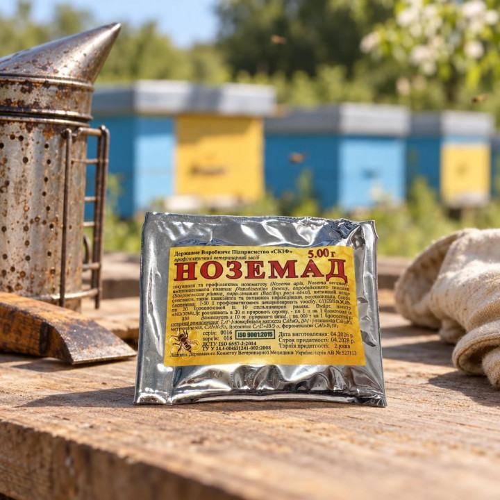 Nozemad 5 g SKIF packet on wooden table with smoker and glove at an apiary