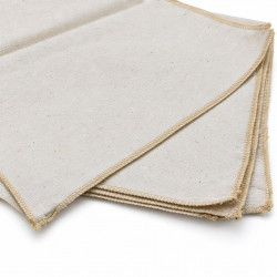 Close-up of beige cloth texture and stitched edges on a white background