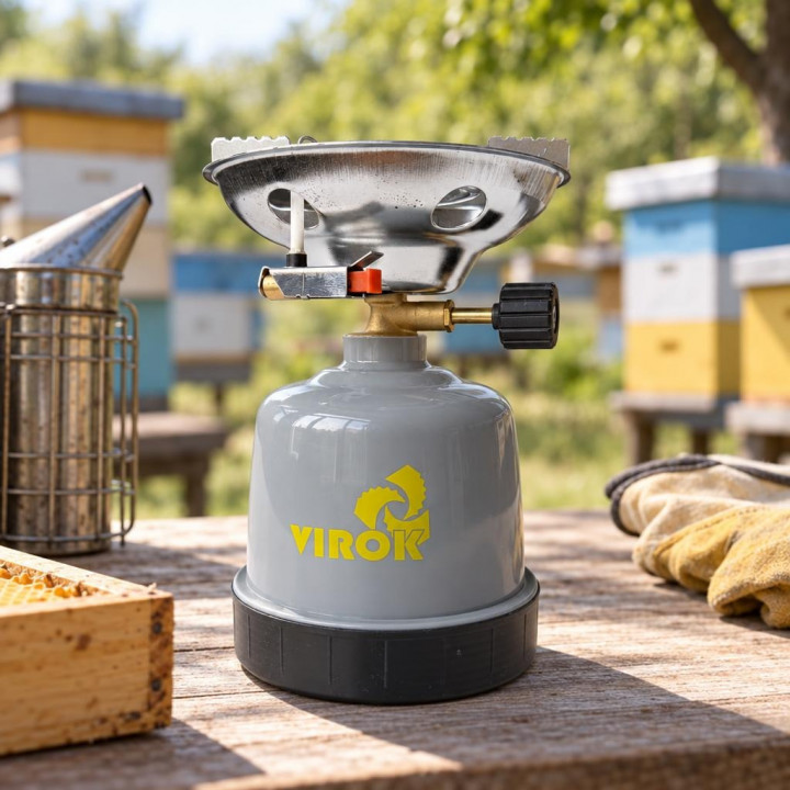 VIROK stove on a table near beehives, with a smoker and gloves nearby